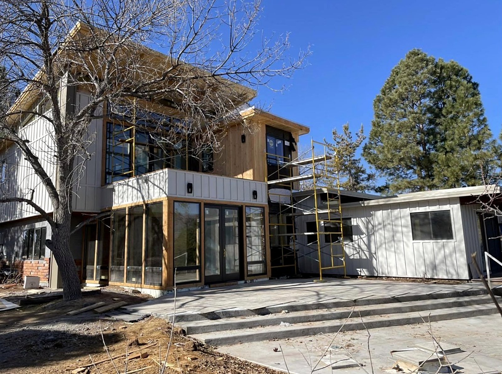Two-story exterior renovation with cedar accents and new patio